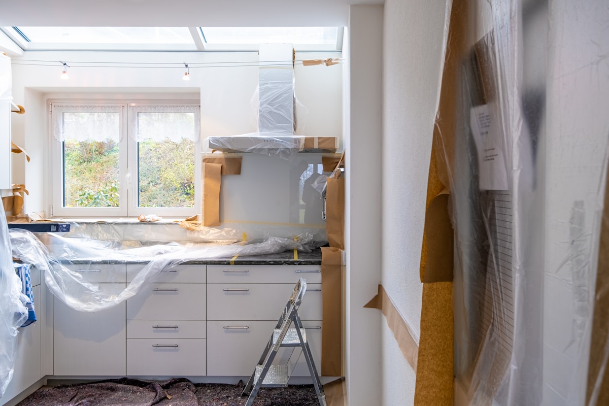Kitchen protected with dust sheets and masking tape during a renovation