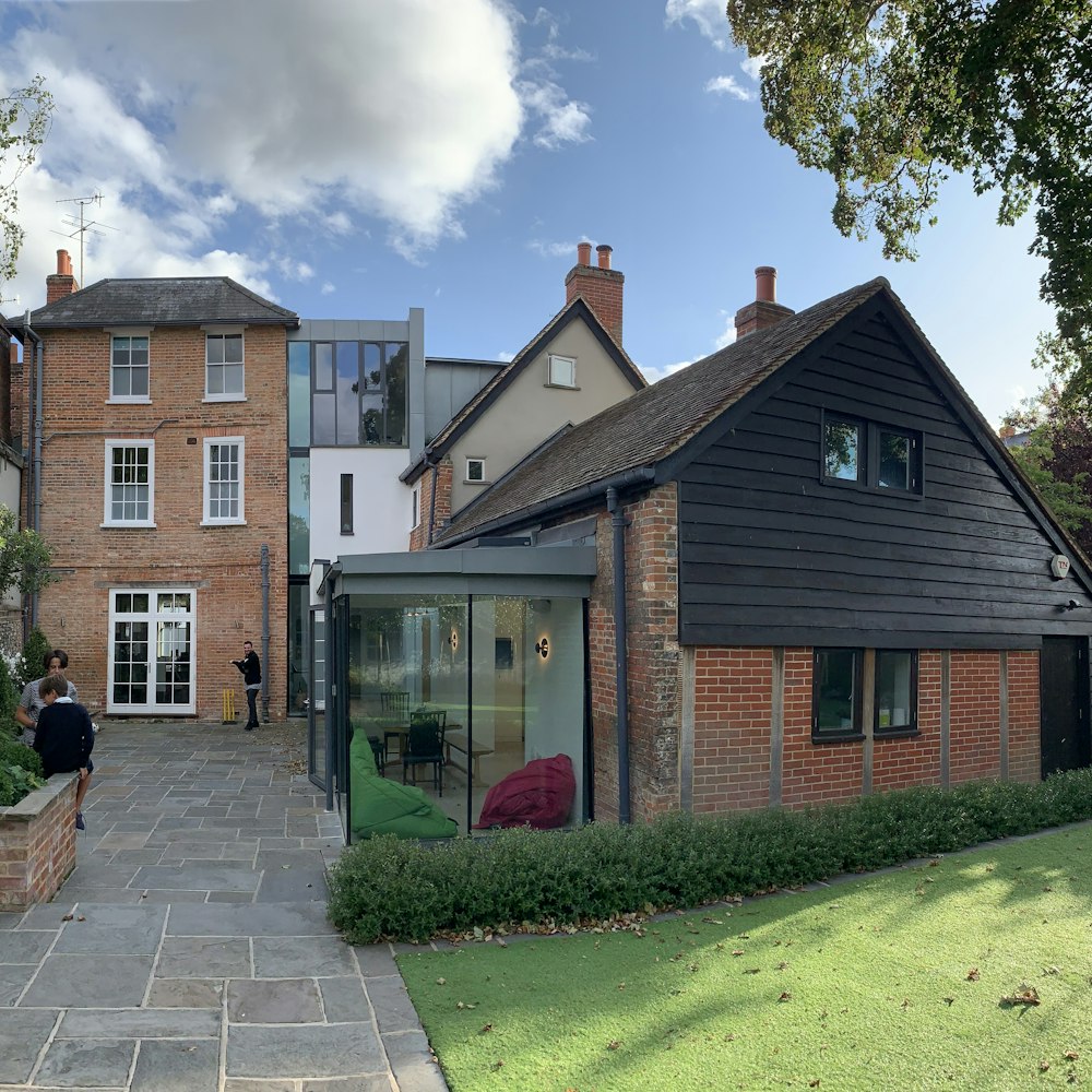 Glazed link extension joining a period house to a brick outbuilding